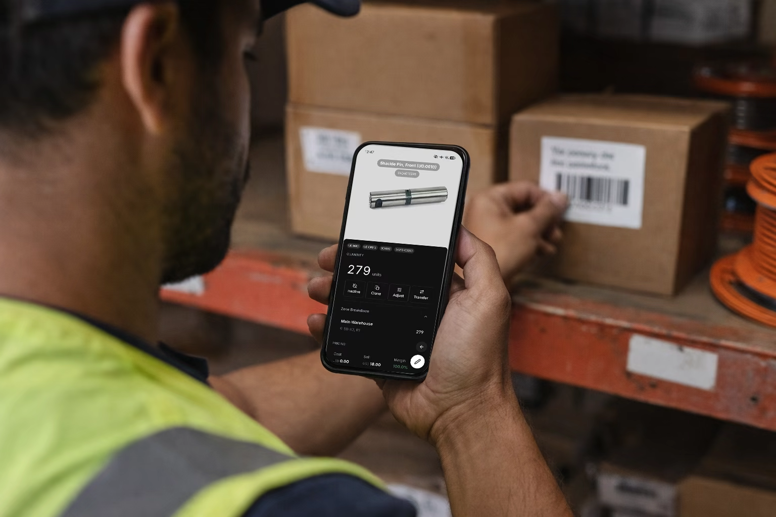 Worker using tablet for inventory management in warehouse